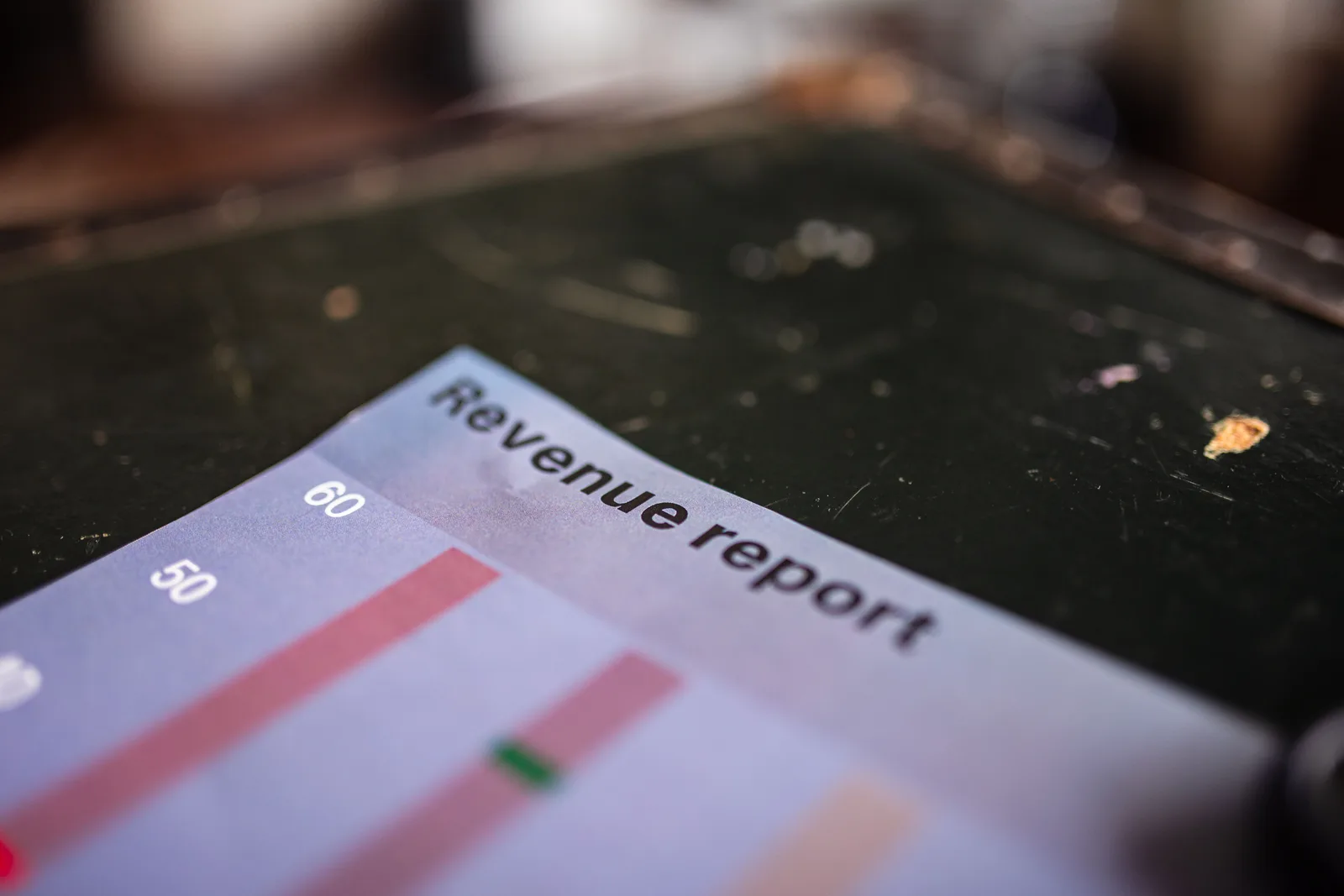 Detailed view of a revenue report featuring a bar chart in an office setting. Newsletter revenue metrics that predict anything