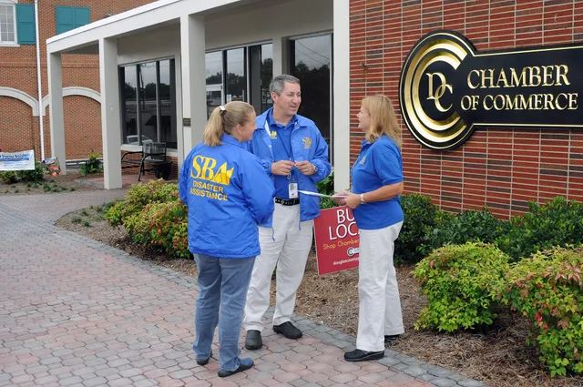 Douglasville, GA, October 5, 2009 -- Small Business Administration Public Information Officer Richard Daigle confers with Customer Service Representatives Carol Dueker and Shery Lavelle in preparation for today's opening of a Business Recovery Center where loan applications, completion assistance, a. SBA loans and resources for US newsletter owner-operators